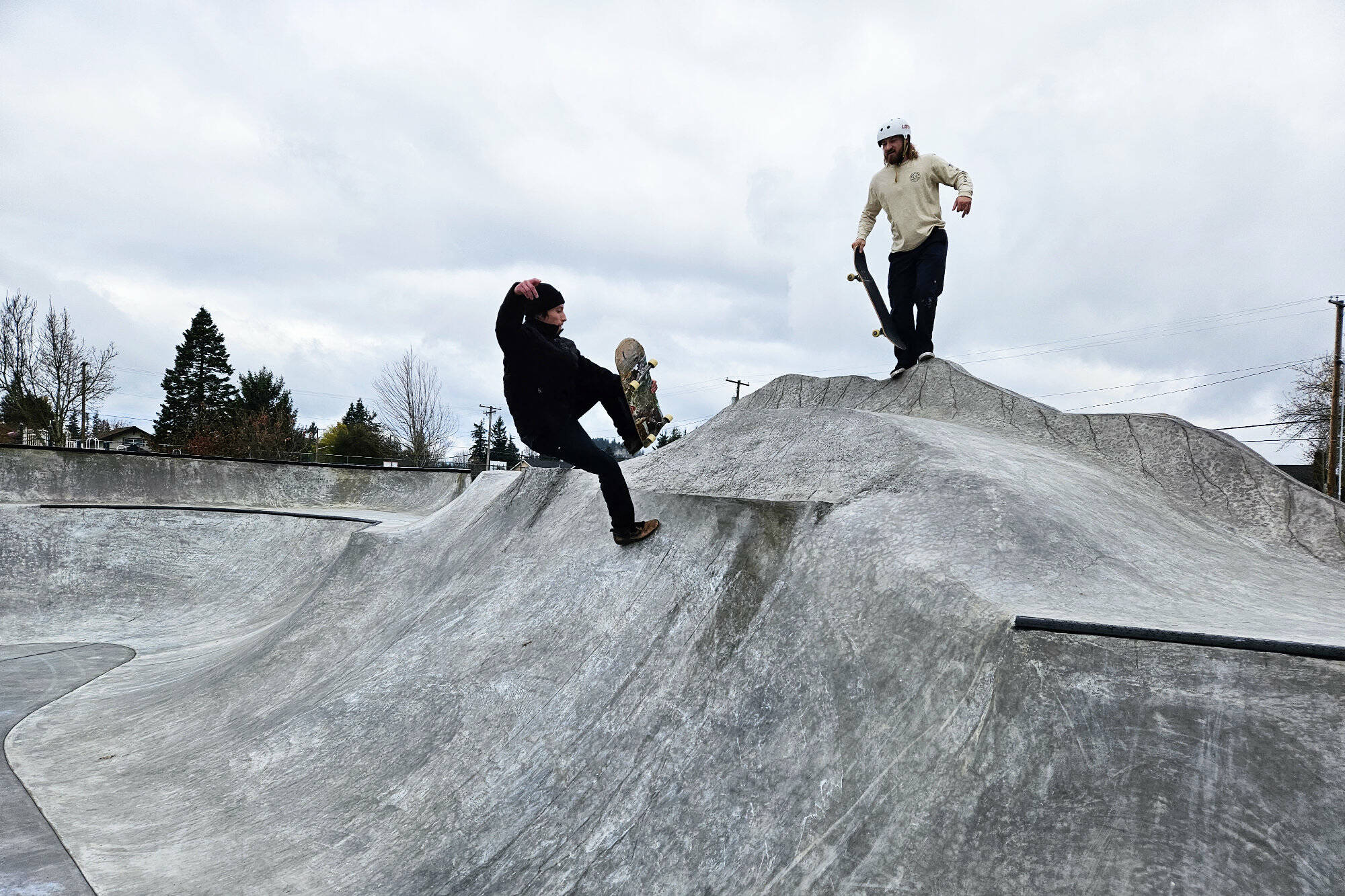 Kasey Craft, in the white, and Joseff Kushmaul, in black, were two of the first people to get rolling on Enumclaw’s new skatepark. Photo by Ray Miller-Still