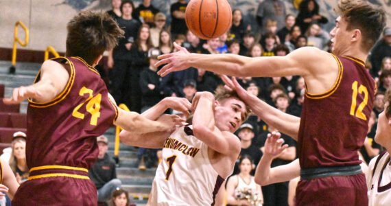 Scrambling for a loose ball during last week's Battle of the Bridge game were Enumclaw's Wyatt Neu (1) and White River's Jace Marecle (24) and Sawyer Bloom (12). Photo by Kevin Hanson