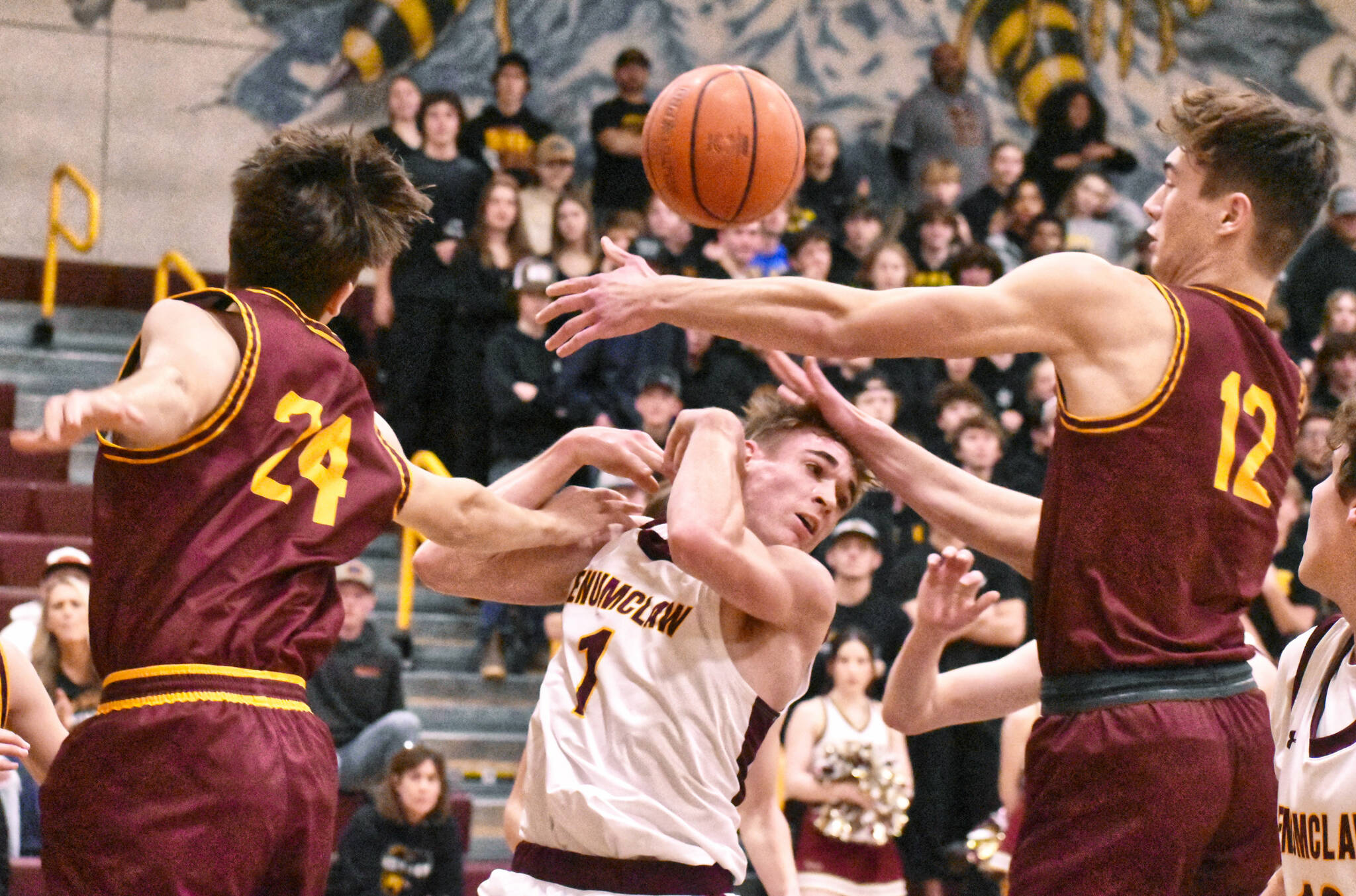 Scrambling for a loose ball during last week’s Battle of the Bridge game were Enumclaw’s Wyatt Neu (1) and White River’s Jace Marecle (24) and Sawyer Bloom (12). Photo by Kevin Hanson
