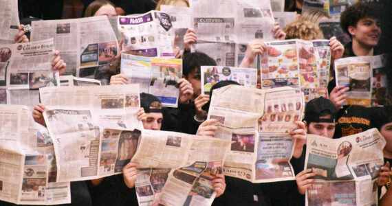Photo by Kevin Hanson
Don’t let anyone tell you no one reads the paper — EHS students held up the Courier-Herald when the White River basketball team was introduced during the Jan. 9 Battle of the Bridge game. Too bad White River had the last laugh, beating the EHS Hornets 51-46.