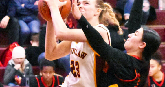 The Enumclaw High girls raced to a 20-point victory Friday night over the visiting Steilacoom Sentinels.  Pictured here is Ava Smith (23), fighting through defensive pressure on a drive to the hoop. With the 61-41 win, Enumclaw improved to 7-1 in South Puget Sound League 2A play, keeping a hold on second place. Photo by Kevin Hanson