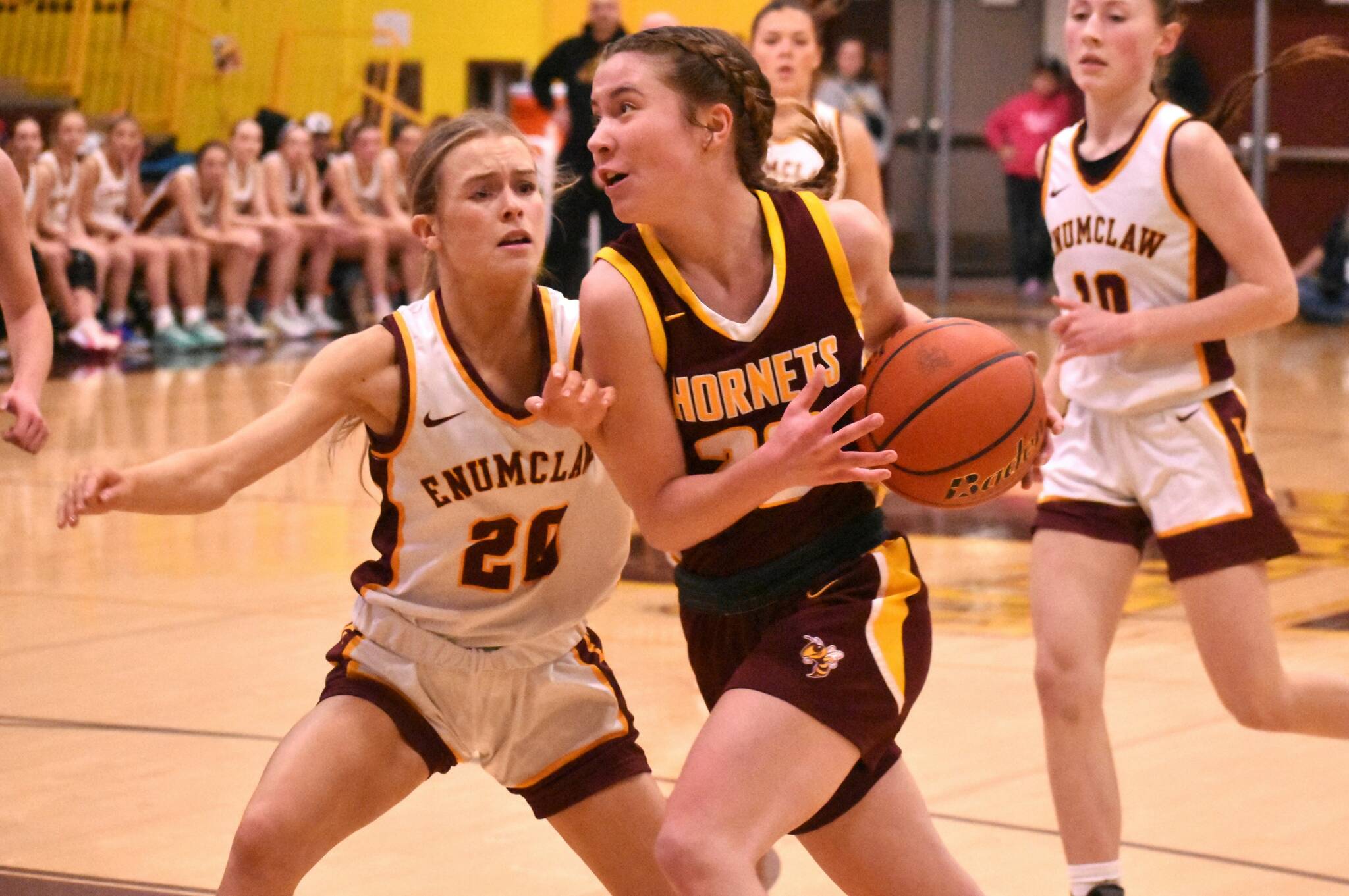 White River’s Maggee Schmitz looks to get past Enumclaw’s Camryn Thomas, driving to the hoop during her team’s Friday night victory. Photo by Kevin Hanson