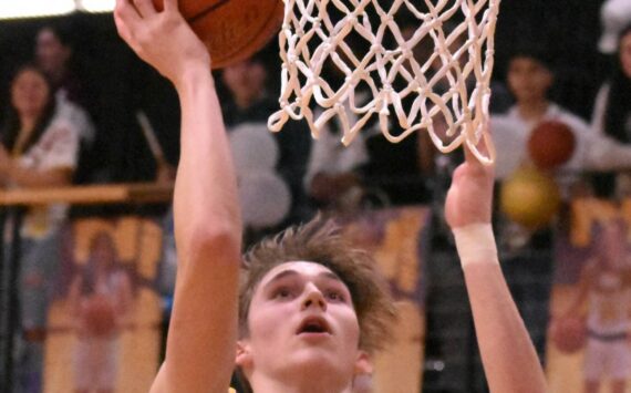 Photo by Kevin Hanson
White River’s Ben Berg goes high for an uncontested bucket during Thursday night’s victory over Enumclaw High.