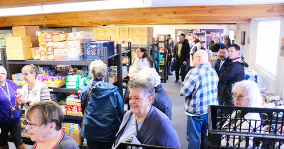 Photos by Ray Miller-Still
Plateau Outreach Ministry’s new food bank is located at 1720 1/2 Wells Street in the Calvary Presbyterian Church Education Building. Pictured are various members of the community at a ribbon cutting and self-guided tour of the few establishment, which is replacing both the food banks at the POM building (Marshall Avenue) and the Enumclaw Food Bank (on Cole Street); also pictured is Executive Director Elisha Smith-Marshall, Cathy Dormaier, vice president of POM’s board of directors, and Food Bank Manager Lynn Lueschen right after the ribbon was cut.