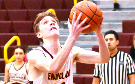 The Enumclaw High boys' basketball team advanced to the state Sweet 16 thanks to three victories in the District 2/3 tournament. Here, Landon Brauer finishes a breakaway layin during the Hornets' February 13, home court victory over North Mason. Photo by Kevin Hanson