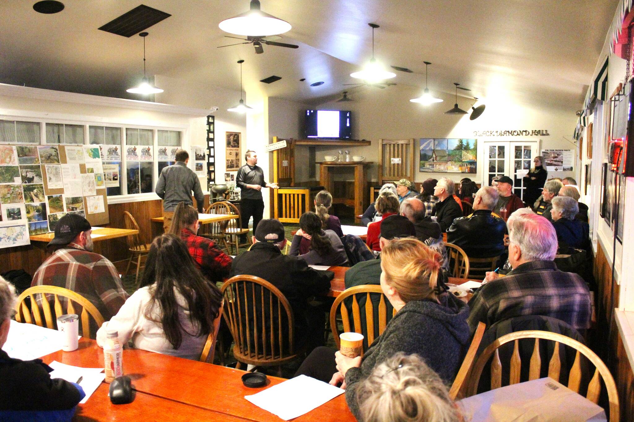 A few dozen concerned Plateau residents attended an informal community meeting about the proposed Seagale gravel mine on Feb. 21. Helping people learn about the area's geological history was Zach Pratt, up in front. Photo by Ray Miller-Still