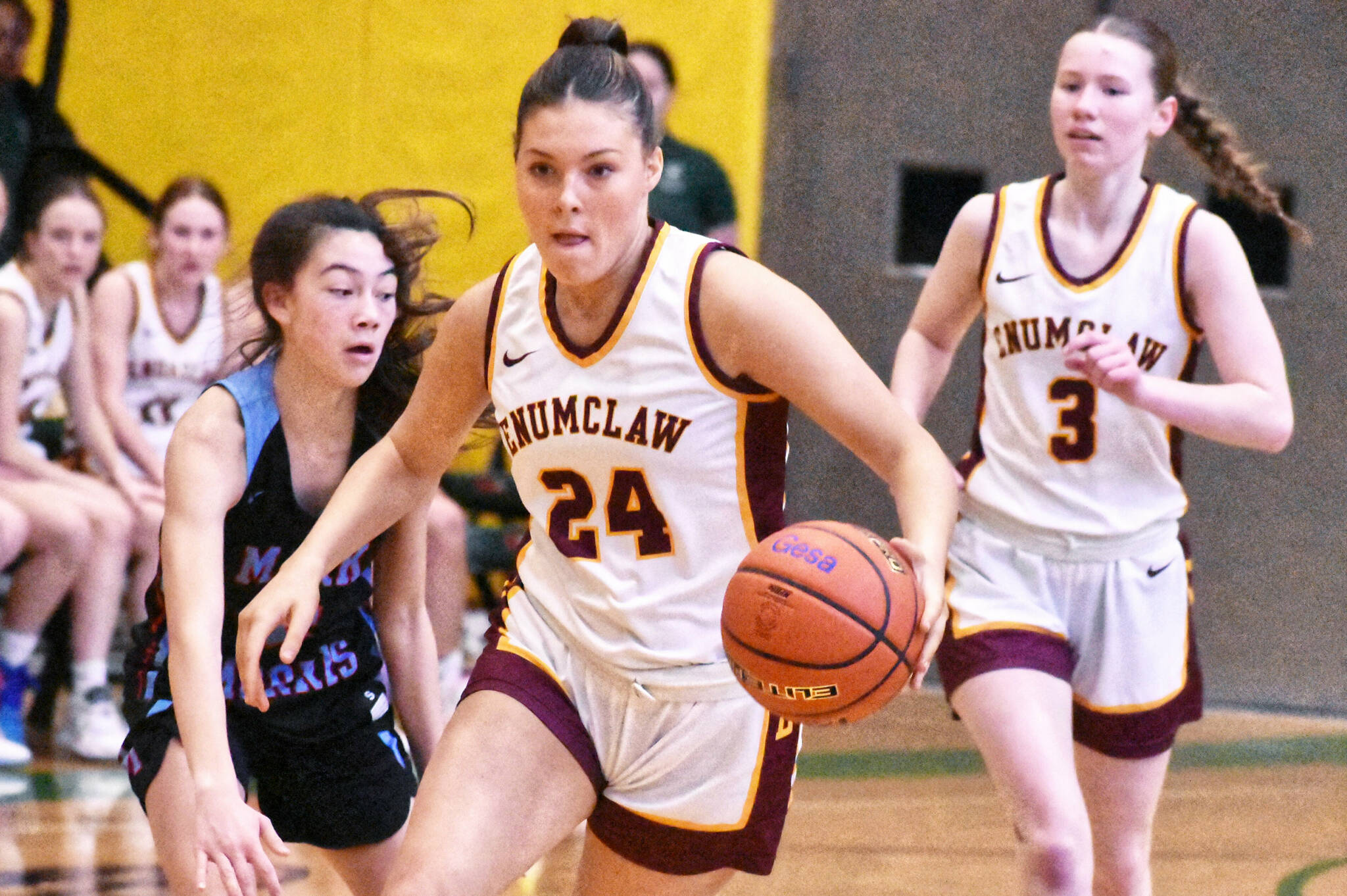 The Enumclaw High girls’ basketball team defeated Mark Morris Saturday afternoon, earning a berth in the state’s Round of 12 and a trip to the Yakima Valley SunDome. In this photo Emma Holt (24) pushes the ball across midcourt while looking for open teammates. Photo by Kevin Hanson