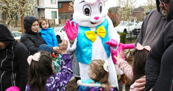 Photo by Ray Miller-Still
Which local Easter egg hunt will you be attending this year? Pictured is a group of sisters high-fiving the Easter Bunny at the Ten Trails event last year. Please note that the neighborhood is not doing an egg hunt this year, but will be hosting an Easter Carnival.
