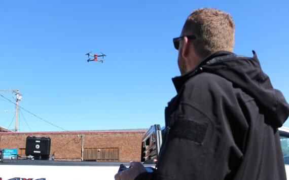 Enumclaw Police Deparment's Commander Mike Graddon flying "Thunderbird," his bright orange drone. Photo by Ray Miller-Still