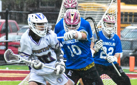 Enumclaw High’s lacrosse team improved to 11-3 overall with a Thursday night victory over the visiting Sumner Spartans. The nonleague contest saw the Hornets jump on top early and coast to a 17-10 win. Success is nothing new to the the Enumclaw crew that captured a Class 2A/1A state title a season ago. Pictured here is defenseman Anthony Mills (10) keeping a Spartan off the attack. For game information about lacrosse (and other spring sports) see the Sports Roundup. Photos by Kevin Hanson