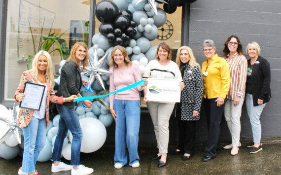 Chamber of Commerce Executive Director Kerry Solmonson, Rainier Foothills Wellness Foundation Executive Director Sara Stratton, Program Coordinator Deanna Kuzaro, Board Vice President Tammi Voorhees, Treasurer Pat Kollen, President Suzanne Lewis, Elaine Parks, and Becky Olness celebrate the nonprofit’s new location on Griffin Avenue with a ribbon cutting. Photo by Ray Miller-Still