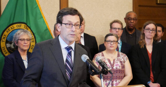 Gov. Bob Ferguson speaks to reporters at the state Capitol on Feb. 27 in Olympia about his plans to cut state spending by about $4 billion over four years. (Photo by Bill Lucia/Washington State Standard)