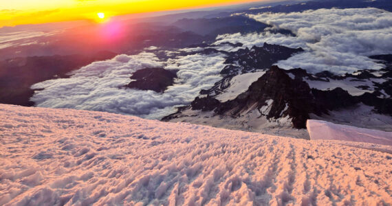 Sunrise at the summit of Mount Rainier is a spectacle only the fittest, bravest, and lucky climbers will experience. Photo courtesy Brent Okita