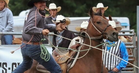 Riley Carel is an unusual rodeo competitor in that he doesn’t run a farm or own a ranch. Instead, he works at Babbitt Insurance. Here he is at the Longview, WA Rodeo in late July. Photo by Elaine Kimball / Elaine’s Images