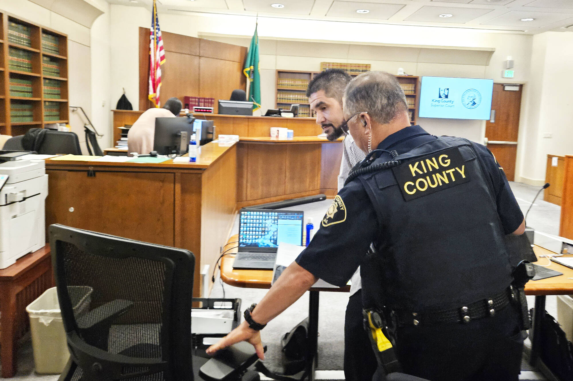 Andrew Baim being led out of court after opening statements concluded. Photo by Ray Miller-Still