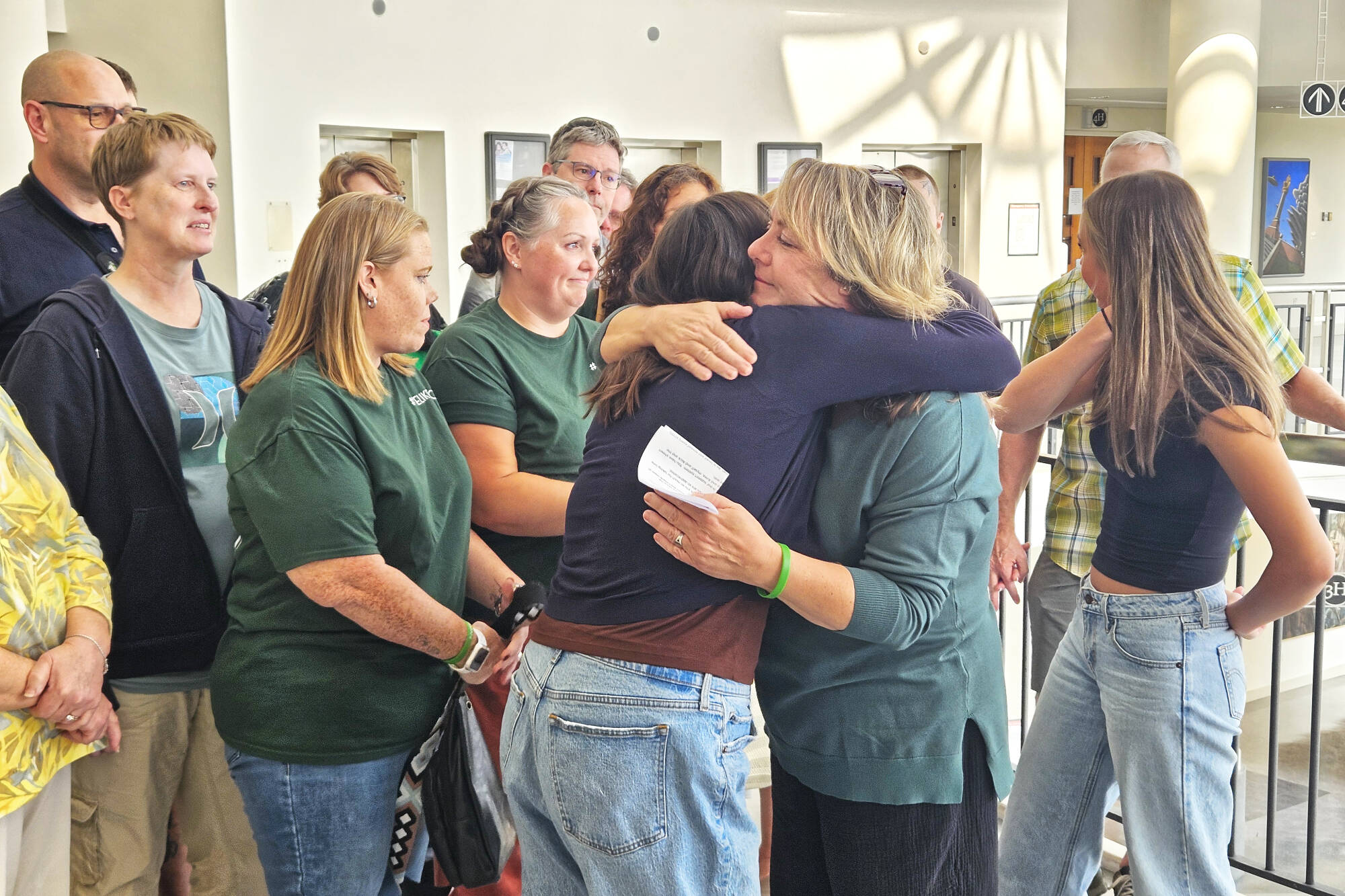 It was an emotional moment for Tanie Valison (pictured here hugging her daughter), her family, and her friends after the guilty verdict was read. Many of her group wore green, Nick Valisons favorite color, throughout the trial. Photo by Ray Miller-Still