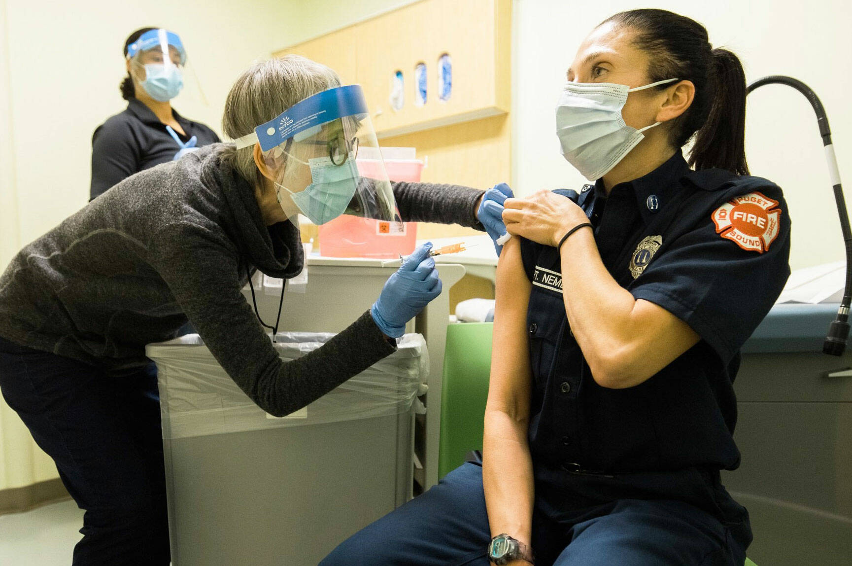 Public Health – Seattle & King County staff administering COVID-19 vaccine to a local emergency responder. COURTESY PHOTO