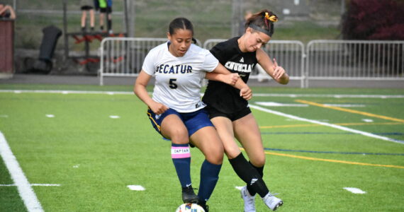 Madison Holden fights for the ball against a Decatur player. Ben Ray / The Herald