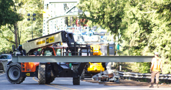 Guy F. Atkinson Construction workers moving a steel beam manufactured by Farwest Fabrication, owned by Enumclaw local Brie Crites. Photo by Ray Miller-Still