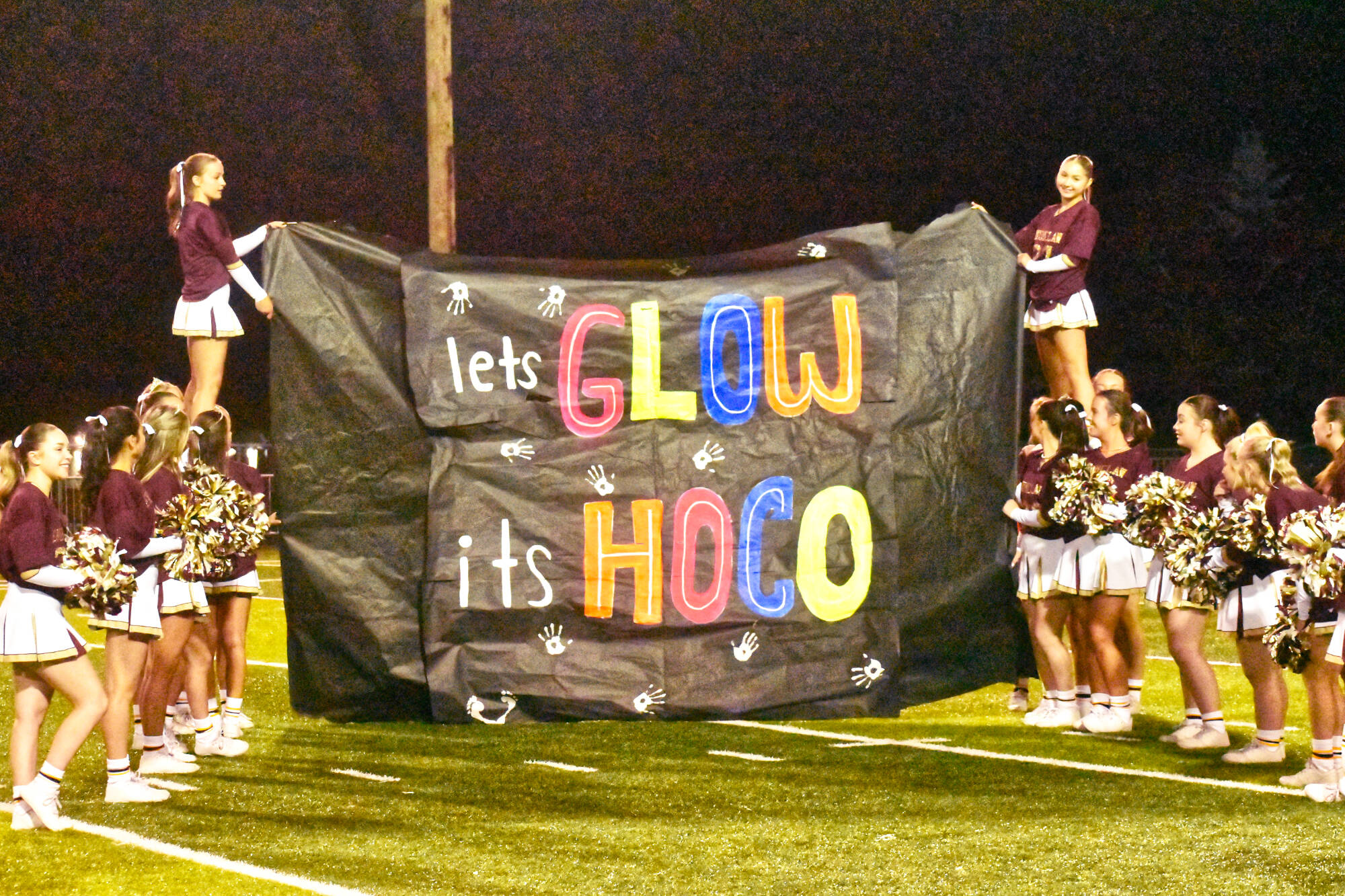PHOTO BY KEVIN HANSON The Enumclaw cheer squad at the Hornet homecoming game, seconds before the team bursted through the sign.