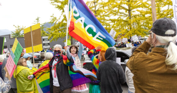 Pro-LGBTQ signs and attire were a common theme at the protest. Photo by Ray Miller-Still