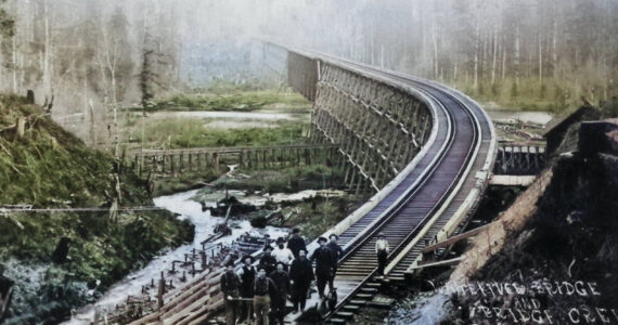 Photo courtesy Enumclaw Plateau Historical Museum 
This 1899 photograph of the recently-completed Norhtern Pacific Railway bridge over the White River looks south from Enumclaw toward Buckley. It was taken by W. S. Walbridge of Slaughter; his lower right inscription reads, “White River Bridge and Bridge Crew, Cascade Division. N.P.R.R.” Boise Creek can be seen to the left of the railroad trestle.