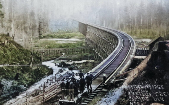 Photo courtesy Enumclaw Plateau Historical Museum 
This 1899 photograph of the recently-completed Norhtern Pacific Railway bridge over the White River looks south from Enumclaw toward Buckley. It was taken by W. S. Walbridge of Slaughter; his lower right inscription reads, “White River Bridge and Bridge Crew, Cascade Division. N.P.R.R.” Boise Creek can be seen to the left of the railroad trestle.