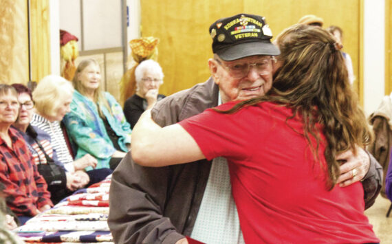 Photos by Ray Miller-Still
Steve Bigger, a Vietnam War veteran, received not just a quilt, but a thank-you hug from Enumclaw Senior Center Recreation Coordinator Rochelle Rogers.
