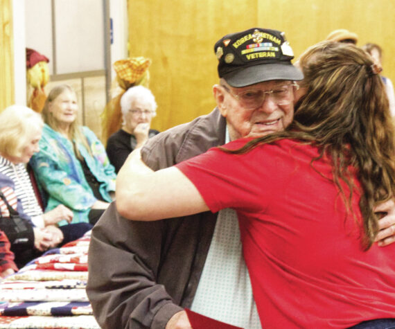 <p>Photos by Ray Miller-Still</p>
                                <p>Steve Bigger, a Vietnam War veteran, received not just a quilt, but a thank-you hug from Enumclaw Senior Center Recreation Coordinator Rochelle Rogers.</p>