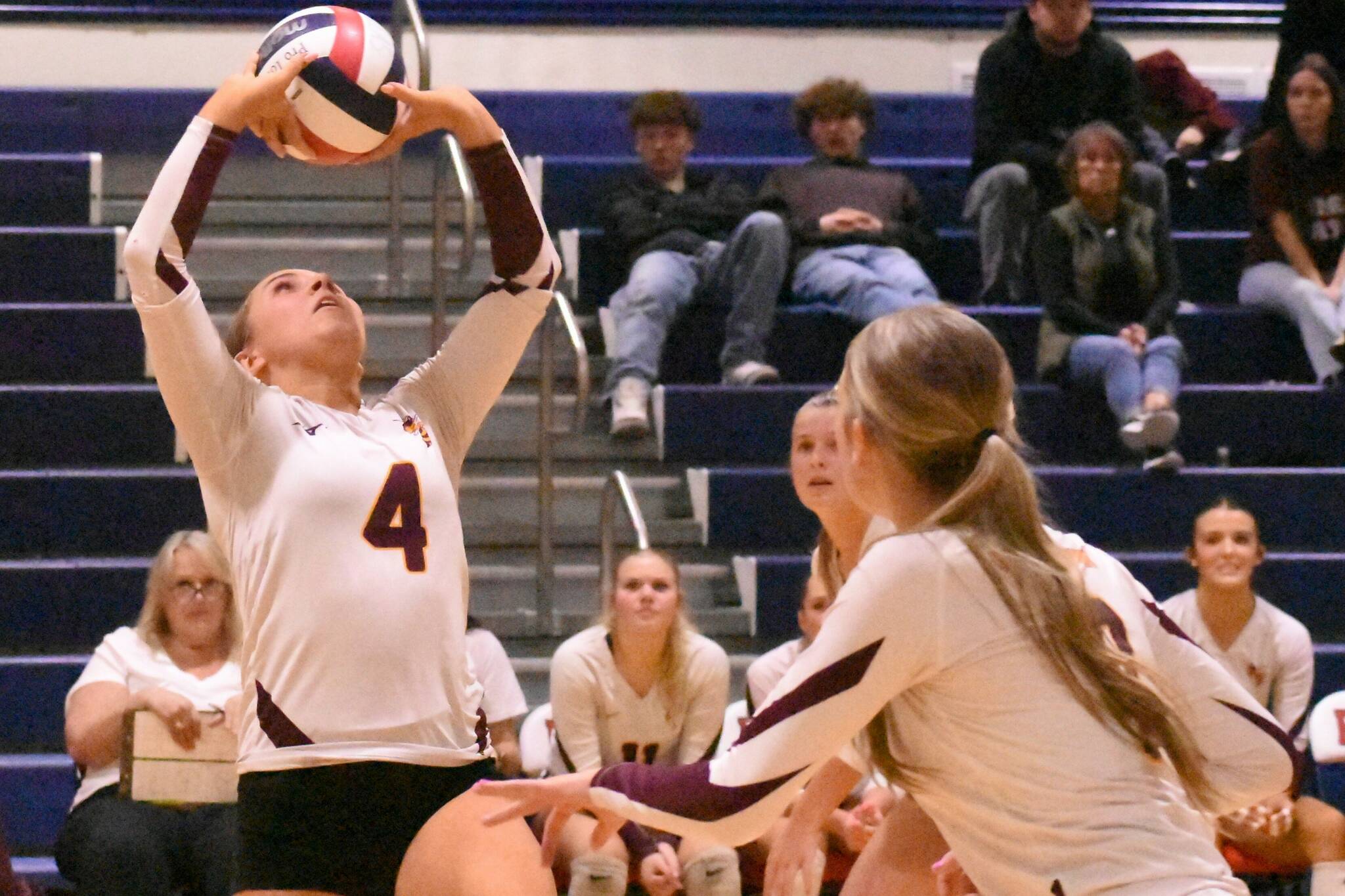 PHOTO BY KEVIN HANSON With teammates rushing the net, White River Highs Taylor Arnold sets up a play during her teams Friday nights district victory.