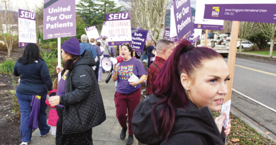 Photos by Ray Miller-Still 
St. Elizabeth workers, friends, and family demonstrated in front of the local hospital last Thursday for higher wages, break nurses, and the financial ability to further their education or renew their licenses. Pictured handling the bullhorn is Cillian Hendrickson, 3, who was there with his mother Amanda, an emergency room nurse.