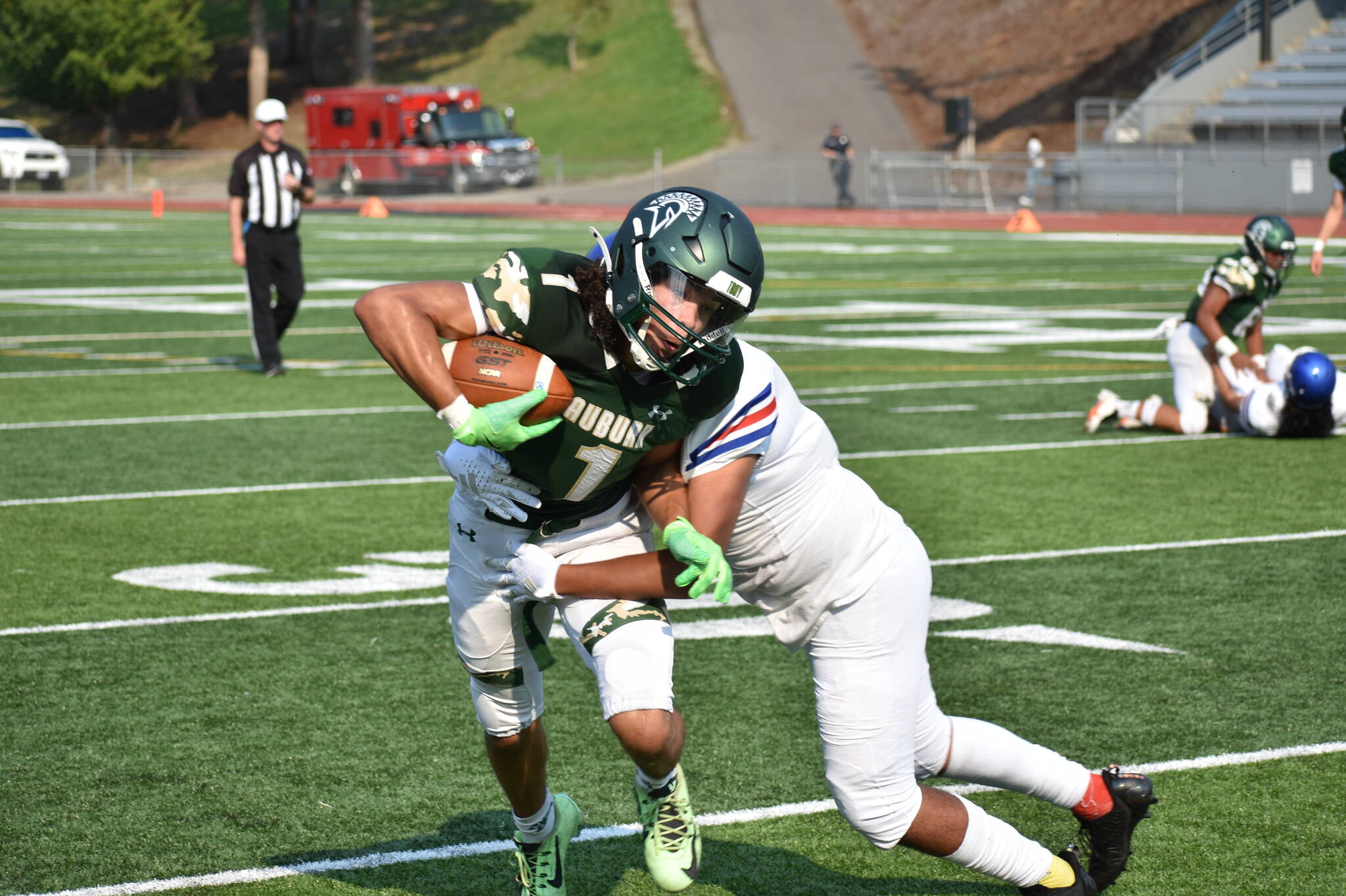 Auburn wide-out Lucas Whitehall-Gilkes takes a hit against the Royals. Ben Ray / Sound Publishing