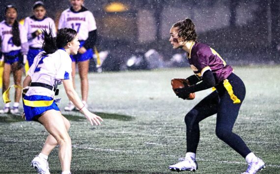 PHOTO COURTESY STEPHANIE FINDLEY 
Enumclaw High quarterback Madison Holden looks for an open receiver while avoiding a Tahoma defender during the Hornets’ first flag football game.