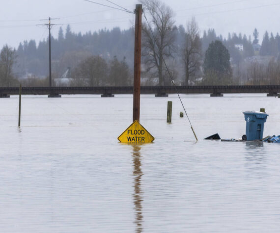 Floodwater from the Snohomish River partially covers a flood water sign on Thursday, Dec. 11, 2025 in Snohomish, Washington. (Sound Publishing photo)