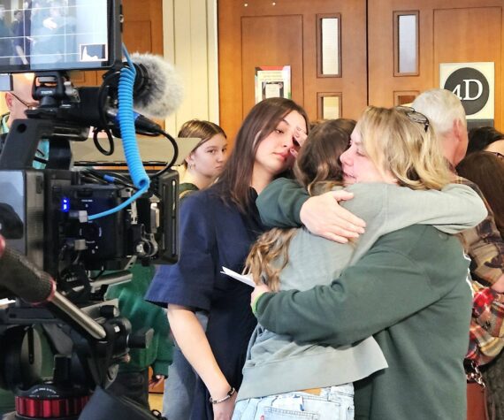 <p>Tanie Valison, the wife of Nick Valison, hugs her daughters after giving a final statement to the media. Photo by Ray Miller-Still</p>