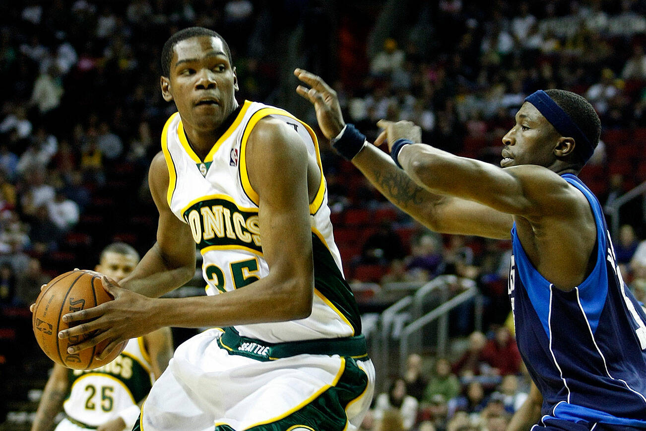 Dallas Josh Howard defends the Sonics Kevin Durant as he looks for the basket. File photo