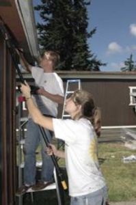 Volunteers help with house painting party