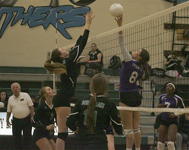 Sumner senior Taylor Comerford and Bonney Lake senior Vegas Casey meet at the net during Thursdays league rivalry game at Bonney Lake High School.