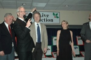 Master of ceremonies John Curley leads a 'heads or tails' game with participants Jim Puttman