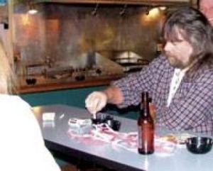 A Bonney Lake Tavern patron enjoys a cigarette on New Year's Eve before the Jan. 2 smoking ban went into effect.