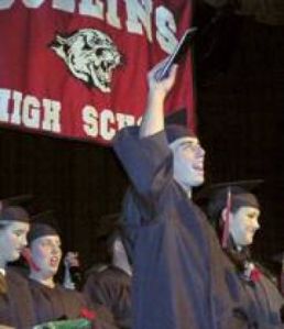 Joshua Caleb Jasper raises his diploma in triumph as this year's Collins High graduates were instructed to rise.