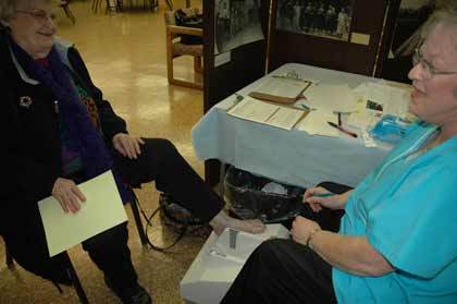 Technician Rachel Hoornstra discusses osteoporosis screening results with Bernie Dunn.