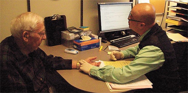 Enumclaw resident Mike Binetti meets with Quan Luu