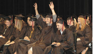 Collins High School graduate Casey Azeltine celebrates graduation with his 2009 classmates Friday night at the White River High School auditorium.