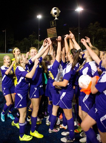 The Sumner Spartans hoist the 2A state championship trophy Nov. 17.