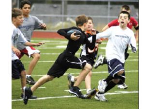 Boys at the Panther Future Champs Football Camp participate in touch football games