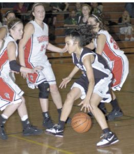 Marcel Pounds takes on a swarm of Tornadoes during opening-round basketball action.