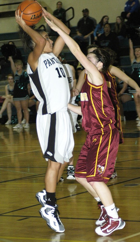 Marcel Pounds shots over a White River players in the Panthers overtime win at home Feb. 4.