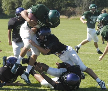 A Sumner Spartan defensive player hits a Kentridge ballcarrier during Thursday's scrimmage at the EWU Football Camp in Puyallup.