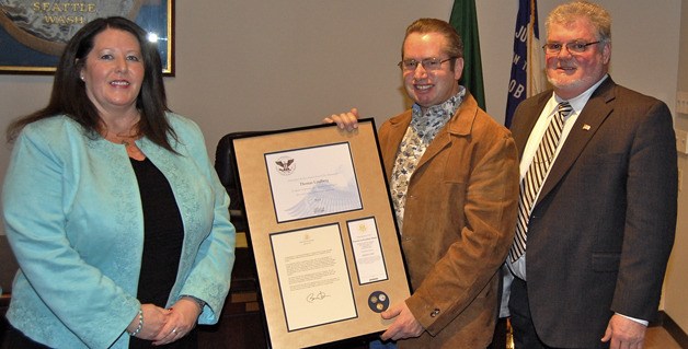 Tom Lindberg of Buckley is honored by Machinists Union District Lodge 751 Secretary/Treasurer Susan Palmer (left) and Vice President Wilson Ferguson on March 13 after receiving a gold-level President’s Volunteer Service Award